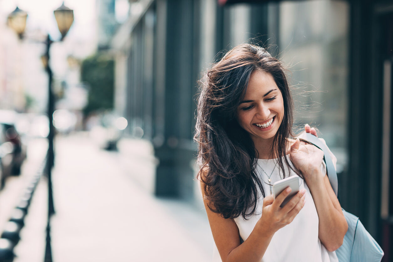 Beautiful woman texting on the street