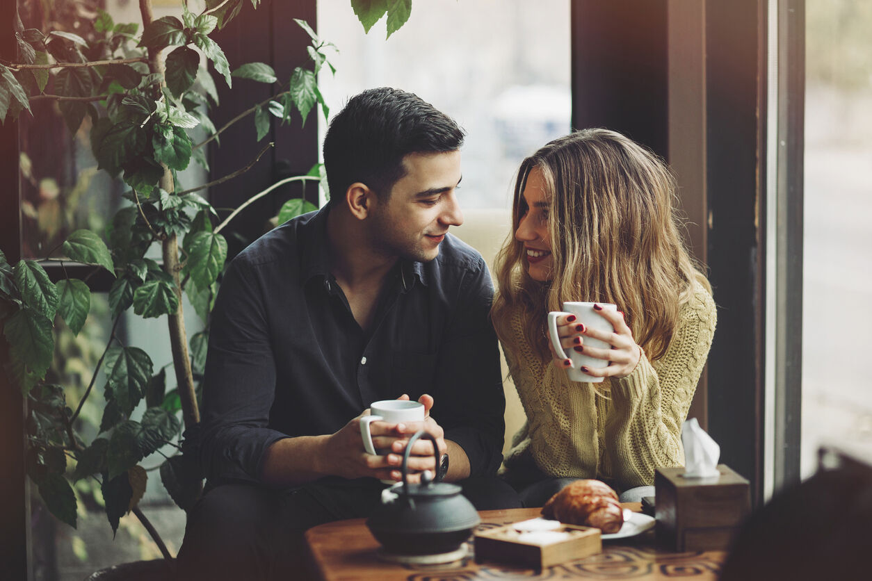 Couple in love drinking coffee and have fun in coffee shop. Love concepts. Vintage effect style picture
