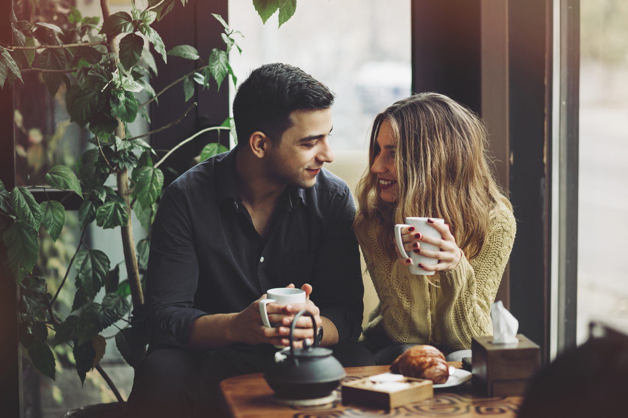 Couple in love drinking coffee and have fun in coffee shop. Love concepts. Vintage effect style picture