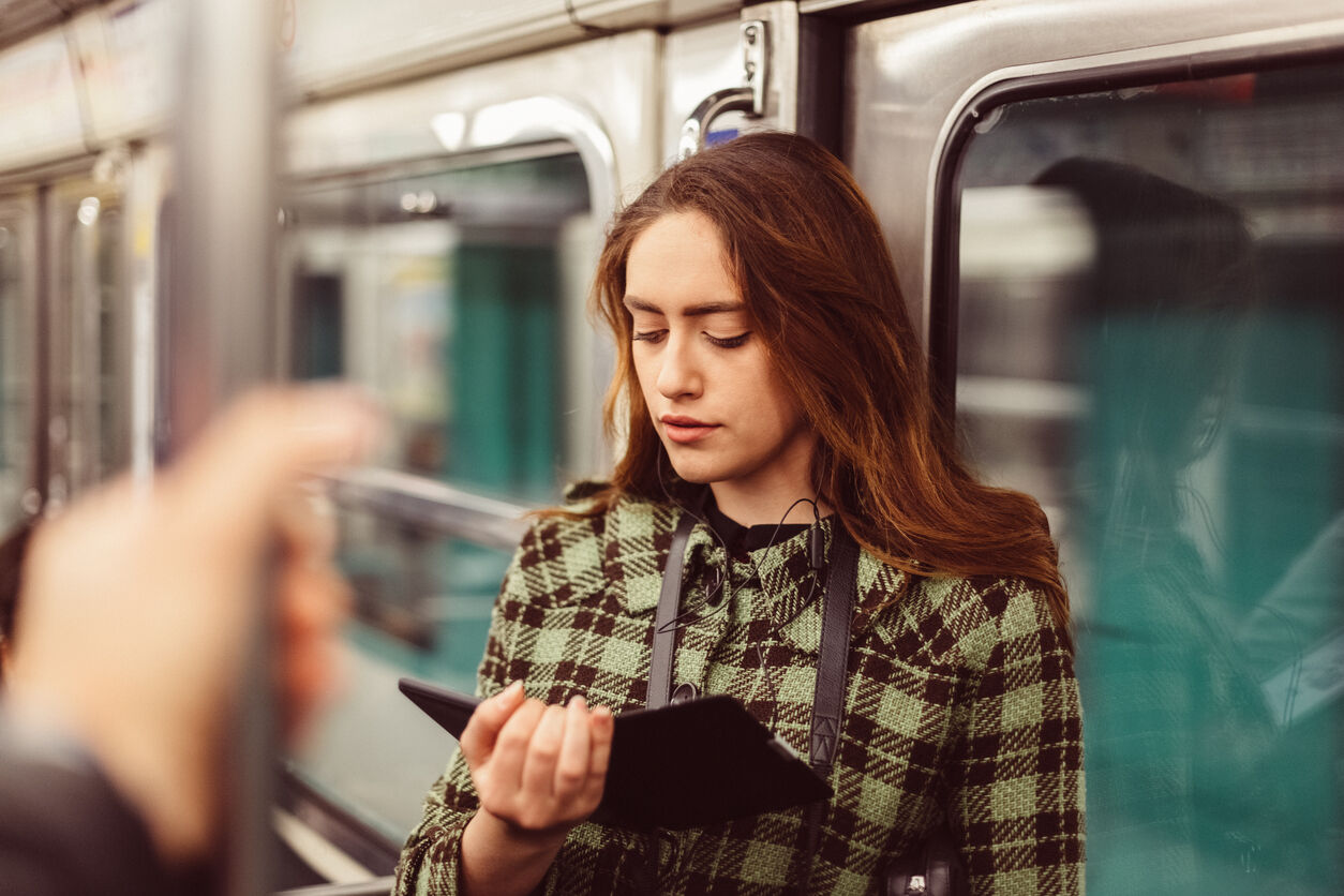 Woman reading e-book in the subway