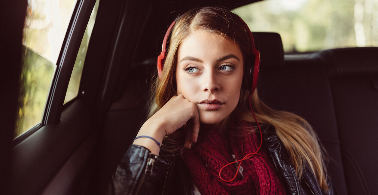 Teenage girl on a road trip with car