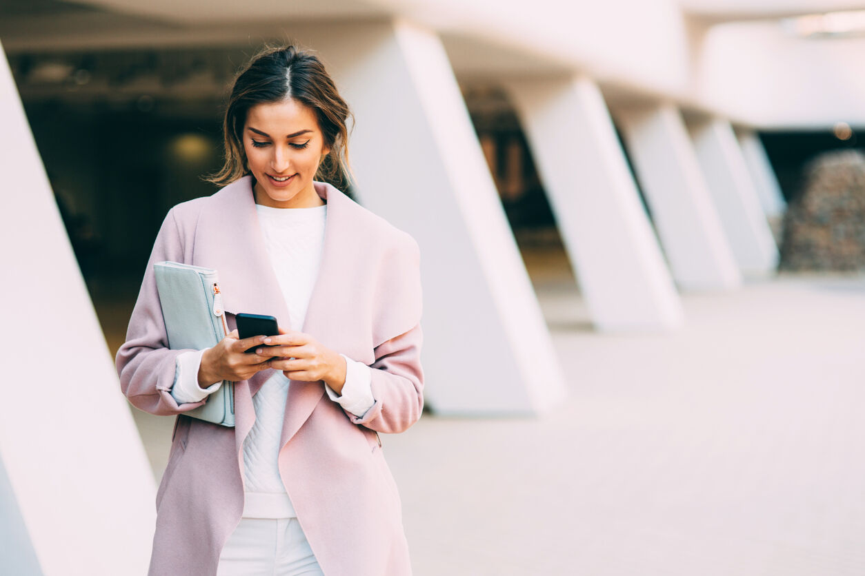 Beautiful elegant woman texting on the phone