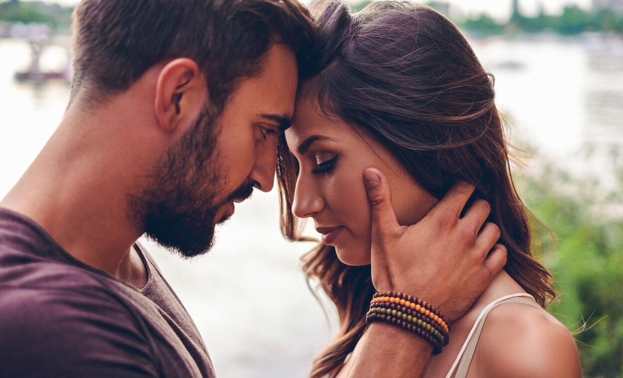 Couple touching with heads before kissing