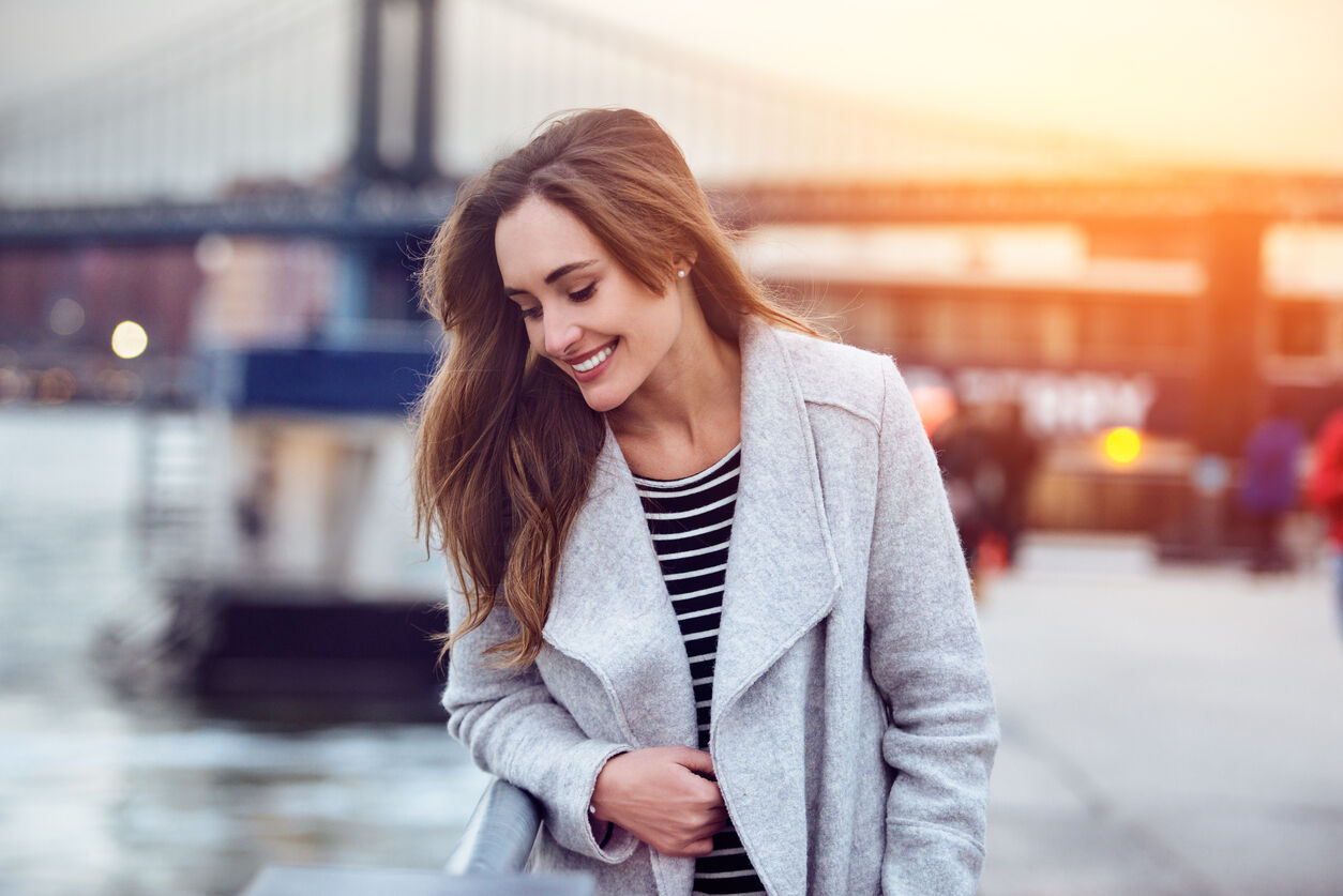 Beautiful happy woman walking and looking down