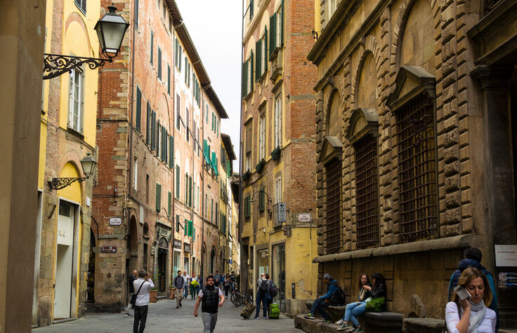 Tourists and locals on Via Cenami, Lucca, Italy