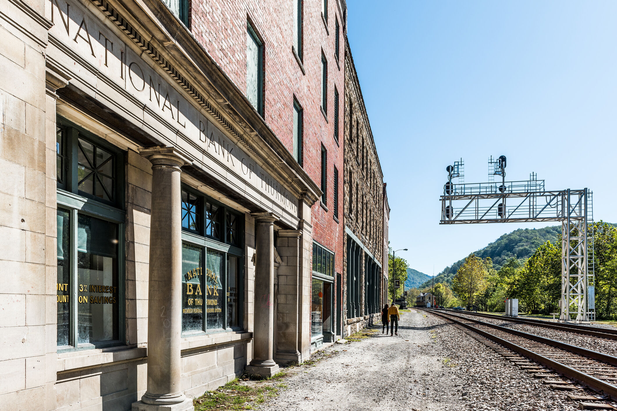 Abandoned closed retro vintage building with National Bank sign in West Virginia ghost town village, railroad