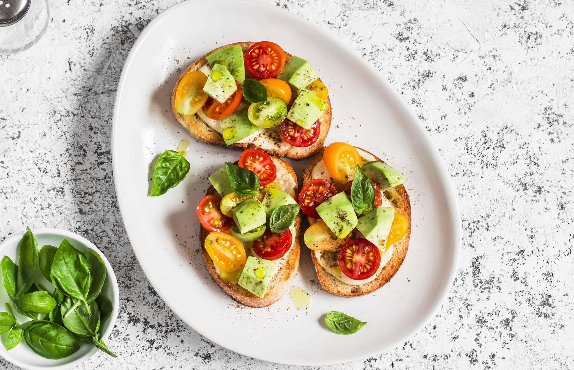 Bruschetta with cherry tomatoes, avocado and basil