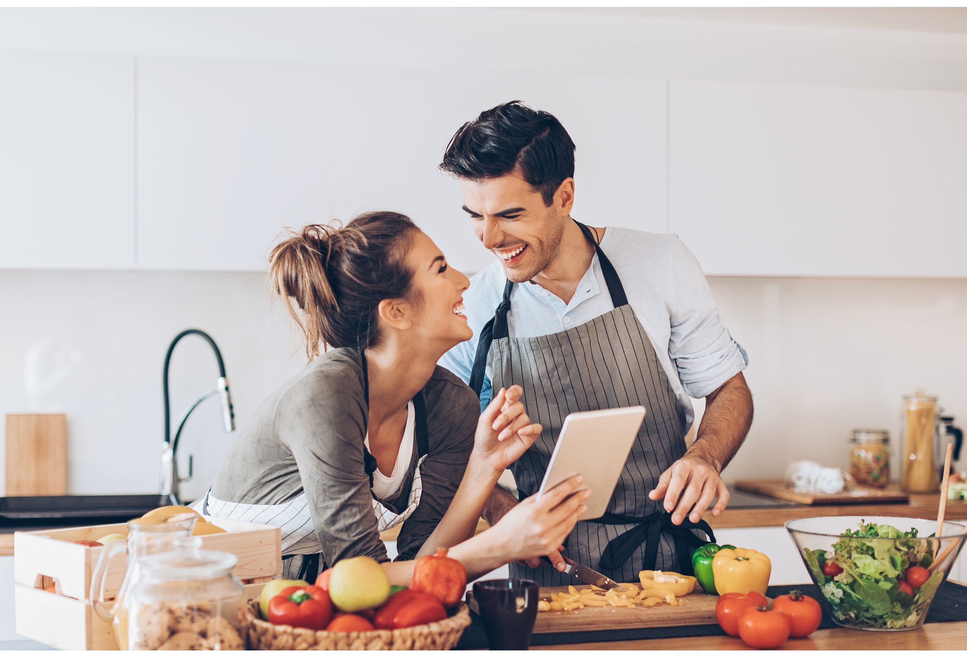 Young couple with digital tablet in the kitchen