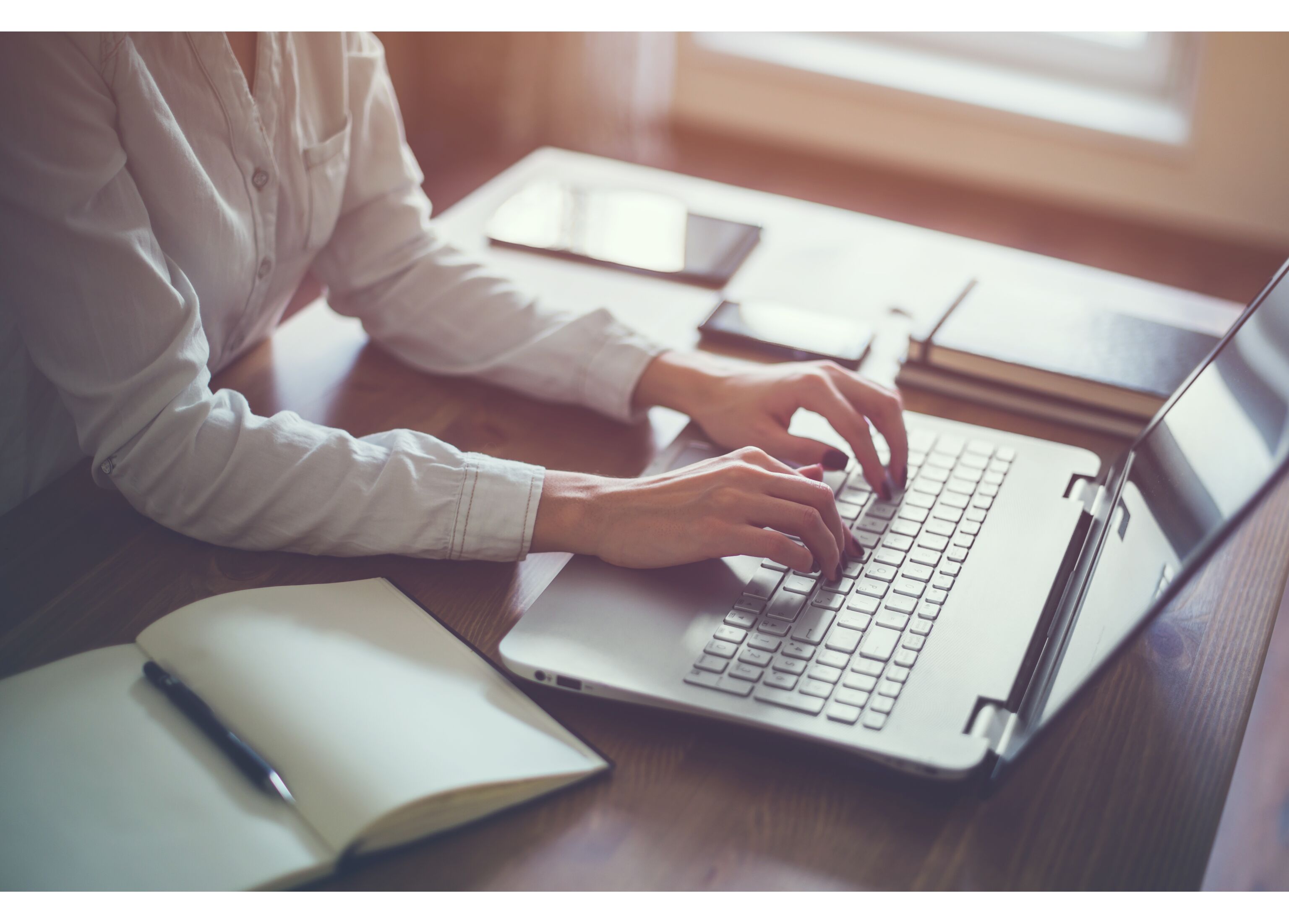Woman working in home office hand on keyboard close up