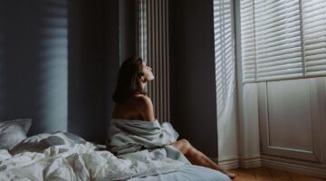 Vrouw op bed.