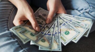 Vrouw houdt geld vast.