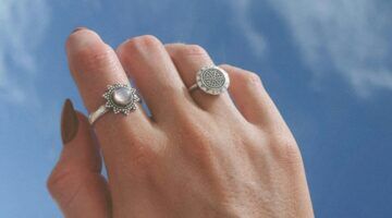 Hand met zilveren ringen.