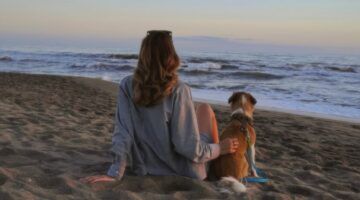 Meisje met hond naast zich.