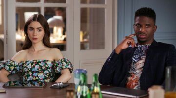 Emily en Julien aan een bureau op kantoor in Emily in Paris.