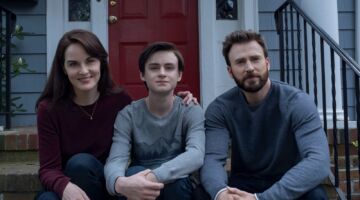 Gezin zittend bij voordeur.