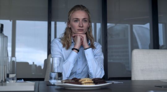 Hoofdpersonage uit de serie steal zit aan tafel.