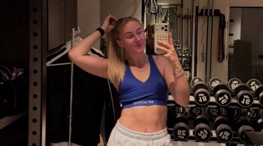 Vrouw voor de spiegel in een sportschool.