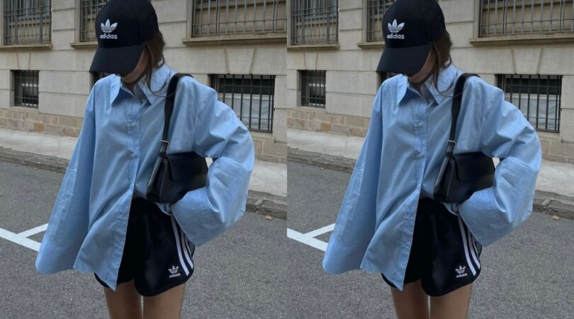 Meisje op de straat met een blauwe blouse en een Adidas broekje.